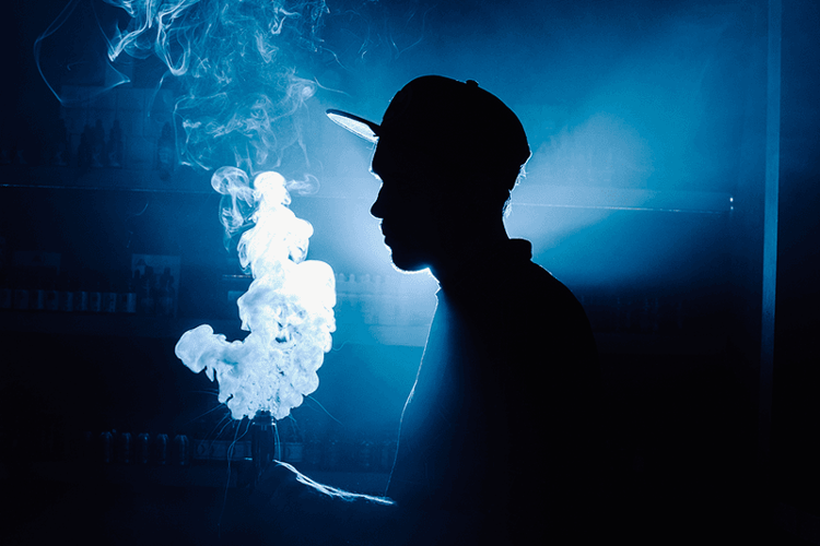 Vaper firing a sub ohm vape device