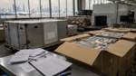 Air cargo containers and customs inspection documents at a Dubai freight terminal