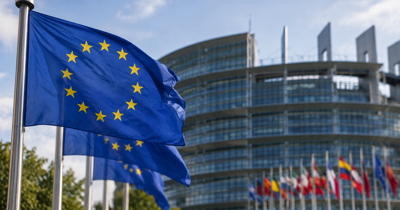 European Union flags outside an EU institutional building in Brussels.
