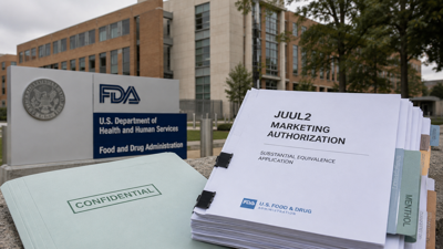 FDA headquarters with regulatory documents referencing the JUUL2 authorization