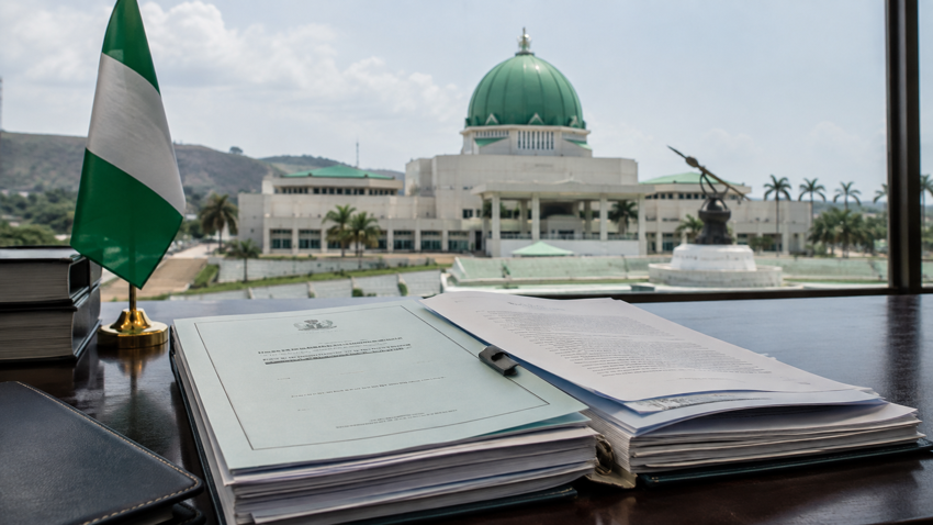 Nigerian flag beside legislative documents representing the dispute over a tobacco control amendment bill.