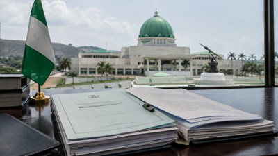 Nigerian flag beside legislative documents representing the dispute over a tobacco control amendment bill.