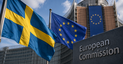 Swedish and European Union flags outside a government building in Brussels