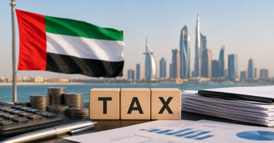 UAE flag beside tax documents and a calculator on an office desk