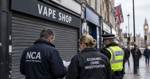 British high street with a closed vape shop as police investigate financial crime